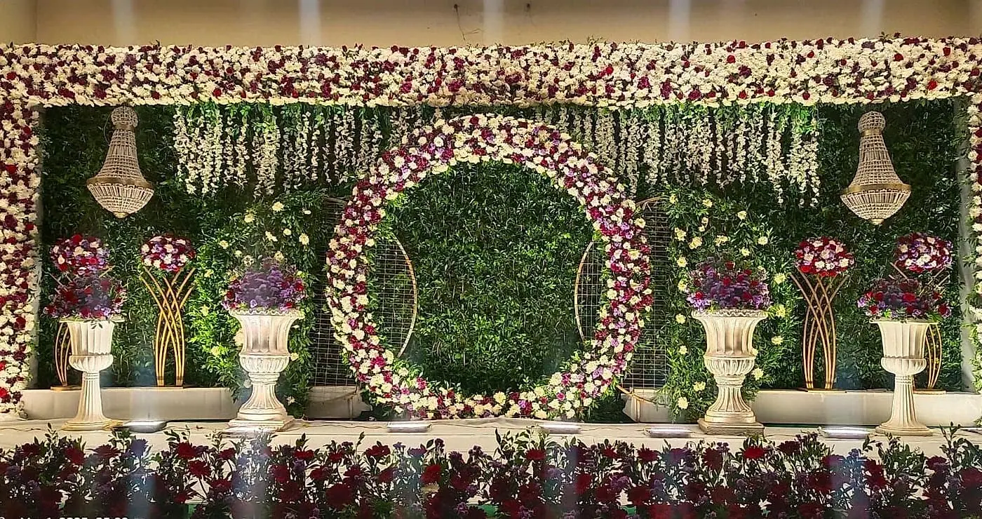 Engagement stage with green floral ring and sofa
