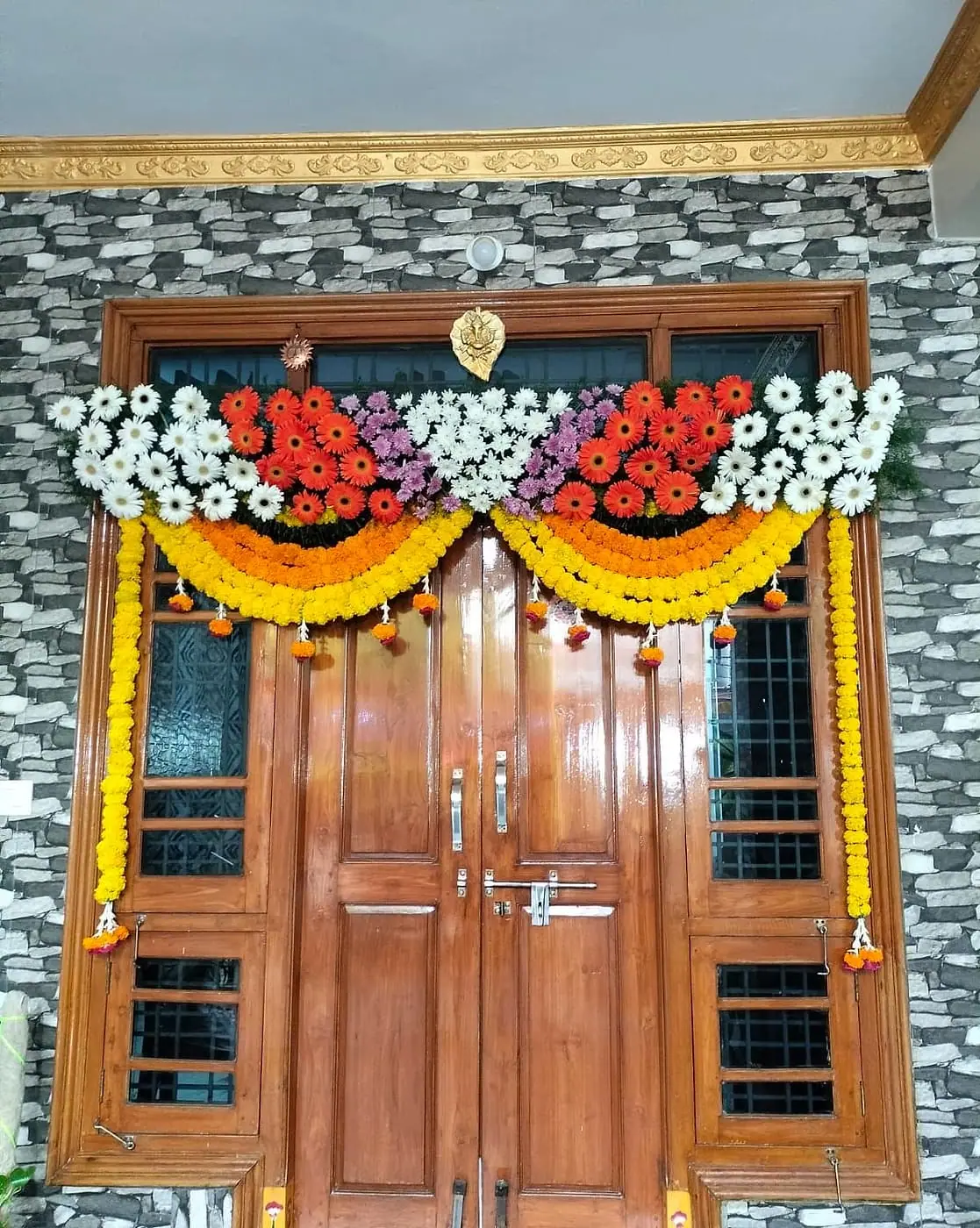 New home's main door decorated with flowers for the gruhapravesham