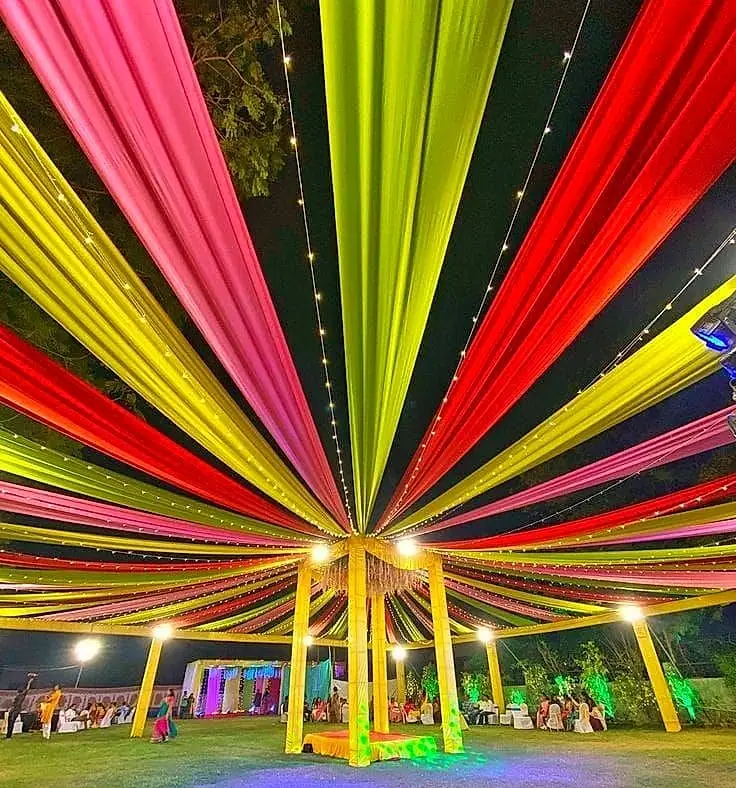 Colourful cloth pandal ceiling with radiating drapes
