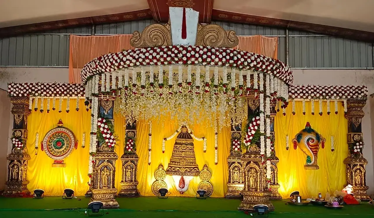 Pelli mandapam with Lord Venkateswara backdrop and yellow drapes