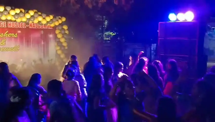 Packed dance floor under colour lights